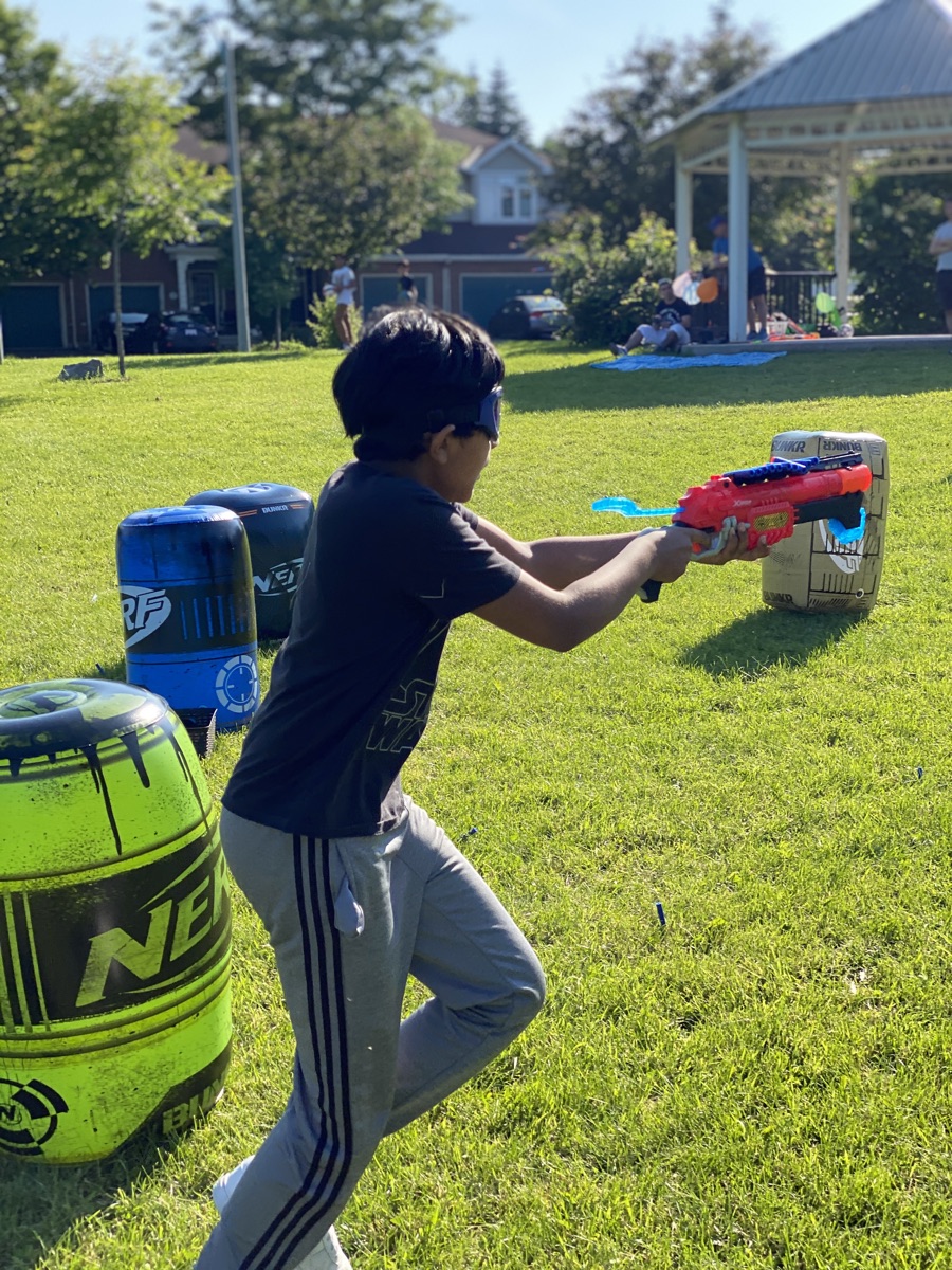 Player sprinting across a backyard battle arena